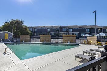 a swimming pool with a building in the background at Highland Mill Lofts, Charlotte